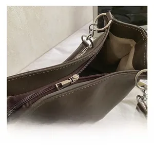 Dettaglio dell'interno di una borsa shopper con zip argentata e cuciture bianche