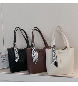 Three textured tote bags in black, coffee, and white with floral silk scarves