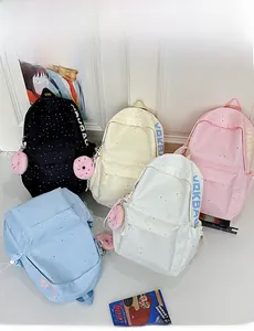 Set of five durable school backpacks in black, cream, pink, blue, and white with dot prints
