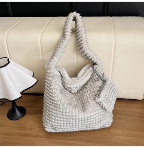 Detail of grey plush tote bag with textured grid pattern and matching coin pouch