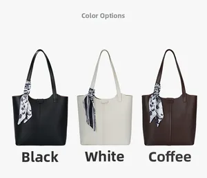 Detail of leather tote bags in black, white and brown with patterned silk scarf handle wrap