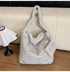 Macro view of light gray plush tote bag featuring a 3D waffle texture and mini coin purse