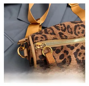 Close-up of golden hardware and leopard print canvas on Boston crossbody bag