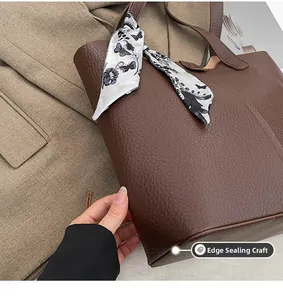 Close-up of deep brown leather tote showing premium edge paint craft and silk scarf