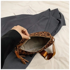Top view of leopard print cylinder bag showing gray fabric lining and interior space