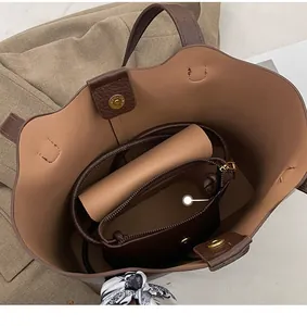 Interior view of brown faux leather tote bag with inner pouch and silk scarf detail