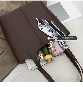 Macro shot of large brown leather tote bag interior with umbrella, tablet and daily items