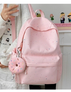 Pink polka dot school backpack featuring a cute doughnut plush pendant on the strap