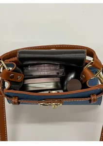 Vertical view of denim bag interior showing storage space for makeup and essentials