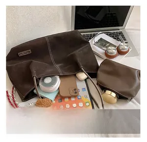 Large capacity brown tote bag showing internal storage for tablet, phone, and cosmetics