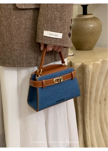 Detail of blue denim and brown leather handbag with gold twist lock and FANTOR logo
