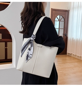 Detailed close-up of white lychee pattern tote bag with a decorative silk scarf
