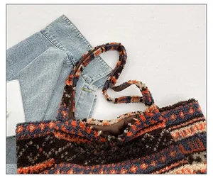 Close-up of geometric patchwork plush tote bag with soft faux fur texture and sturdy handle