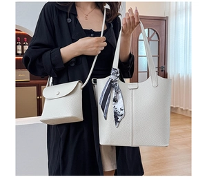 Detail of white lychee pattern tote bag and small crossbody bag set with scarf handle