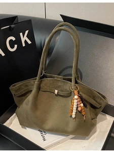 Olive green suede tote bag with bohemian beaded charm and side buckles in a luxury gift box