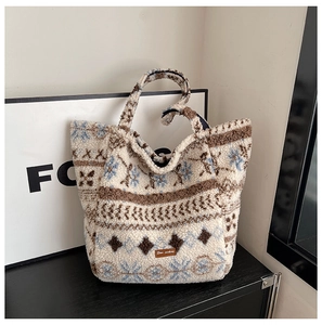 Detail of Sherpa tote bag featuring Nordic snowflake patterns and leather logo tag