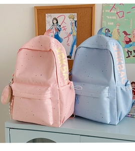 Detailed view of water-resistant nylon campus backpacks with dots and side letter prints