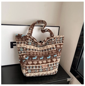 Detail view of ethnic lamb wool tote bag with reindeer pattern and brand leather patch