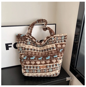 Close-up of winter lamb wool tote bag with brown jacquard floral patterns and leather tag
