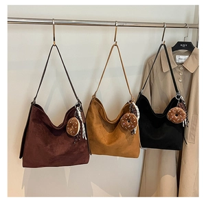 Three large matte hobo bags in coffee, camel, and black with plush donut charms
