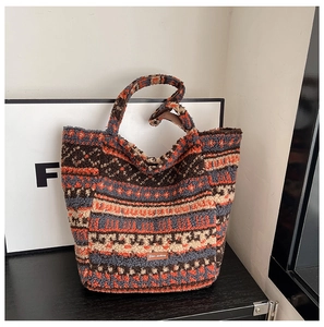 Detail showing plush tote bag texture with colorful ethnic patterns and leather label