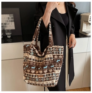 Detail of plush tote bag showing retro jacquard pattern and brown leather brand label