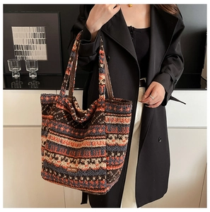 Detailed knit texture of ethnic tote bag with geometric stripes and Stay picking label