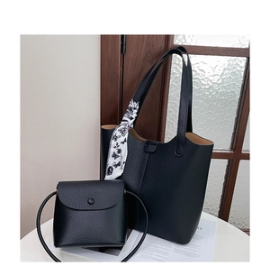 Close-up of black lychee grain tote bag and crossbody set with silk scarf detail