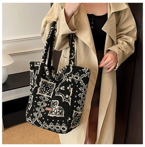 Detail of ethnic jacquard pattern and leather label on plush wool tote bag