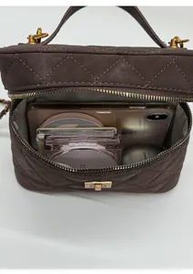 Internal storage view of the brown quilted leather cosmetic bag with gold zipper detail