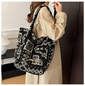 Detail of Sherpa fleece tote bag with black and white ethnic pattern and leather logo