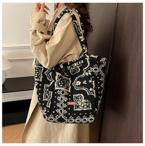 Side view of large paisley print plush tote bag showing soft lamb wool texture