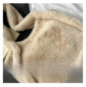 Close-up of beige plush faux fur texture on a large capacity shoulder tote bag