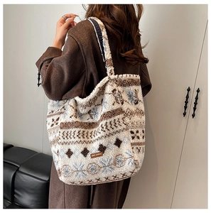 Detailed texture of ethnic tote bag made of soft lamb wool with geometric patterns