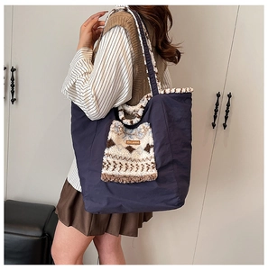 Detail of blue tote bag with fuzzy white fleece trim and patterned front pocket