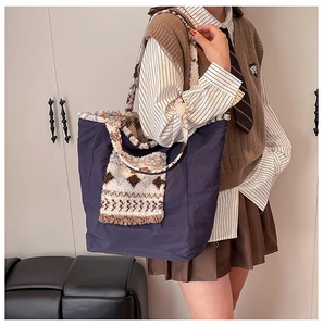 Detailed side view of ethnic tote bag featuring contrast fleece patchwork and large capacity