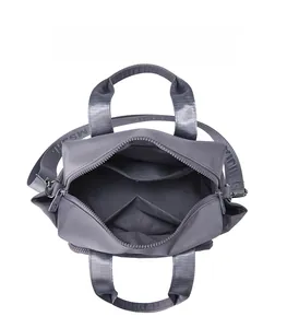 Interior view of grey nylon handbag showing multiple compartments and spacious storage