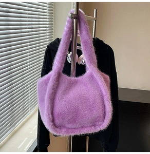 Detail showing soft purple faux fur texture and wide shoulder strap of the tote bag