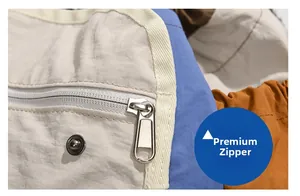 Macro detail of high-quality textured metal zipper and snap button on outdoor backpack