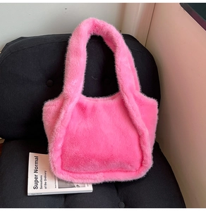 Close-up of fluffy bright pink faux fur tote bag showing soft plush texture and wide handle