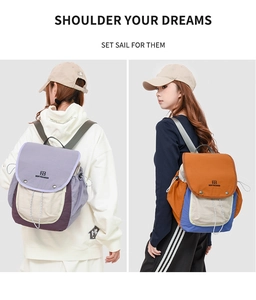 Detail of color-block backpack showing drawstring closure and metallic buckle fastening