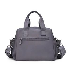 Detailed view of dark grey waterproof nylon handbag with multi-pocket design and strap