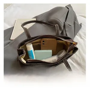 Top view of brown tote bag interior with contrast stitching showing daily storage capacity