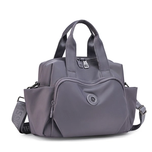 Detail of multi-pocket dark grey waterproof nylon handbag with wide logo shoulder strap