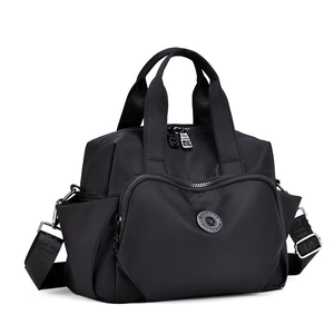 Macro detail of waterproof black nylon bag featuring multiple pockets and durable zippers