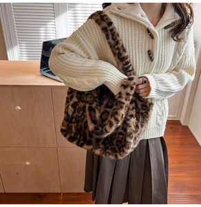 Detailed view of plush leopard print faux fur tote bag paired with winter knitwear