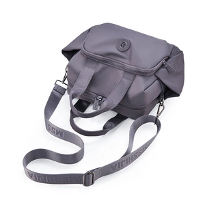Macro shot of waterproof nylon texture and dual-handle details on grey handbag