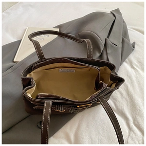 Internal view of brown tote bag showing large capacity and contrast stitching detail