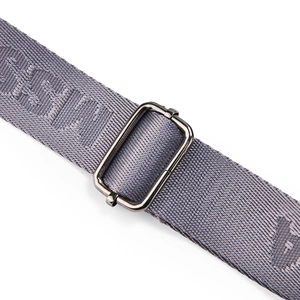 Macro shot of grey woven strap with silver metal buckle and textured brand pattern