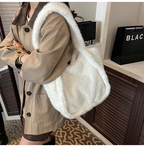 Close-up of fluffy white faux fur tote bag showing soft texture and spacious design
